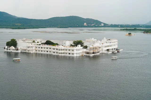 A white marble palace resting on the water of Lake Pichola in Udaipur