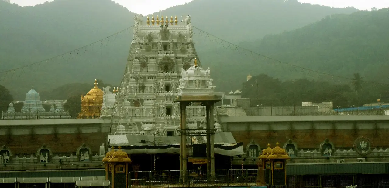 The white gopuram of the Sri Venkateswara Swamy temple at Tirumala, with the Seshachalam hills behind